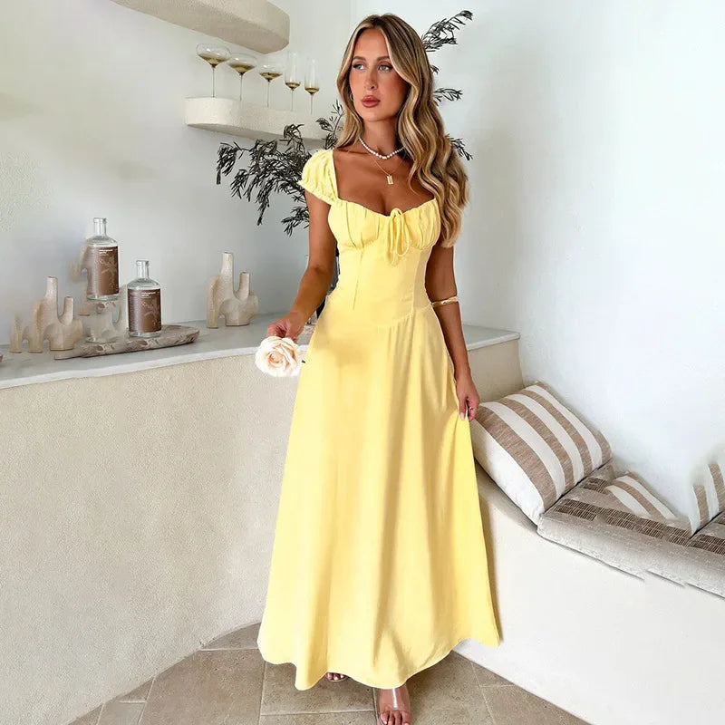 Yellow Aigerim elegant maxi evening gown by Harrow, featuring an empire waist and flowing design for formal occasions.