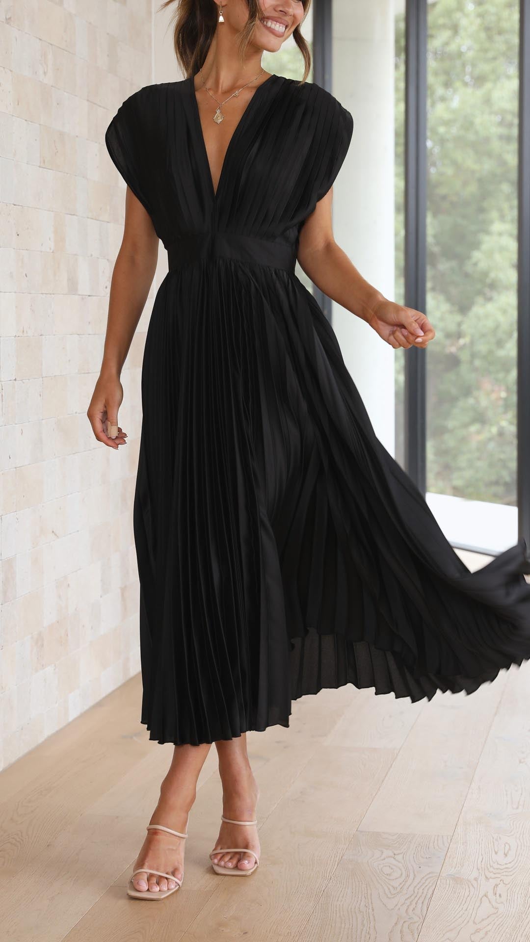 Elegant flowing maxi dress for women by Harrow, featuring pleated fabric and a graceful silhouette in the image.