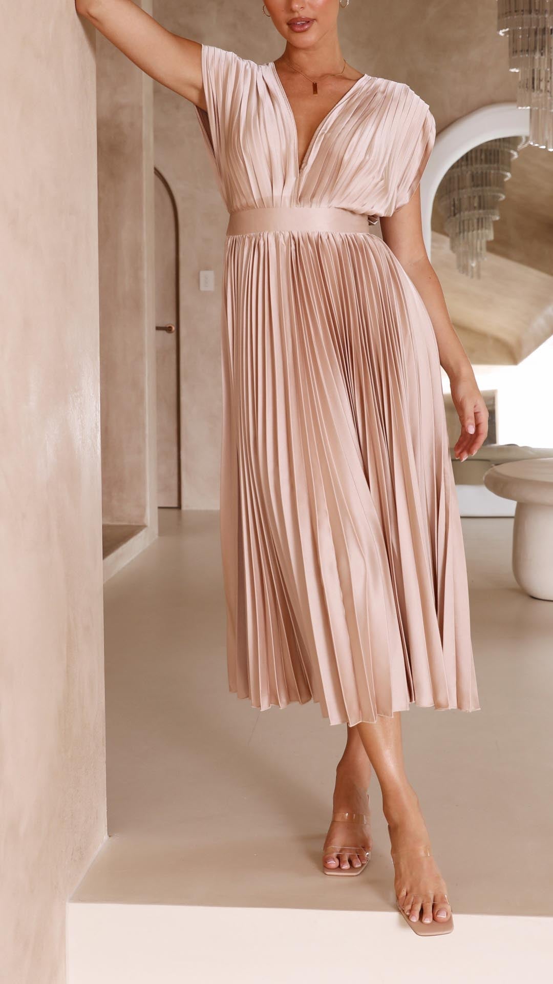 Elegant flowing maxi dress for women featuring pleated design by Harrow, displayed in a stylish, full-length view.