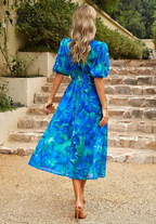 Elegant floral dress for women, the Monica by Harrow, with vibrant summer floral pattern and lightweight fabric.