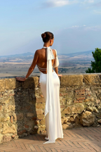 Elegant white wedding guest maxi dress by Harrow, featuring a flowy design and intricate details, perfect for formal occasions.