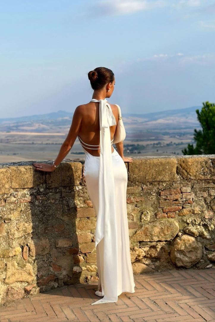 Elegant white wedding guest maxi dress by Harrow, featuring a flowy design and intricate details, perfect for formal occasions.