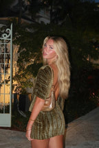 Women wearing the Adriana Harrow romantic off-shoulder mini dress, backless design, ideal for cocktail parties.