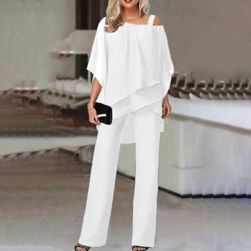 Women wearing a stylish cold shoulder wide-leg jumpsuit set by Harrow, featuring batwing sleeves and a fashionable cocktail look.