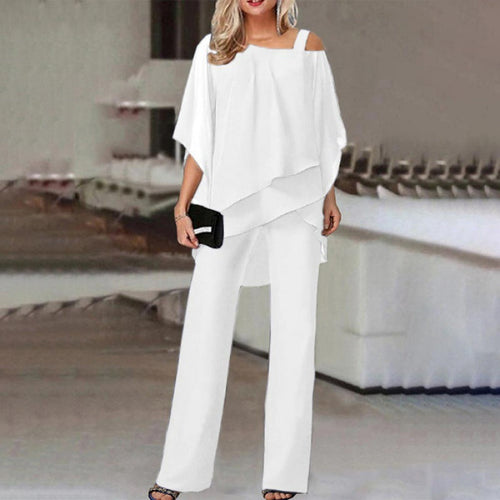 Women wearing a stylish cold shoulder wide-leg jumpsuit set by Harrow, featuring batwing sleeves and a fashionable cocktail look.