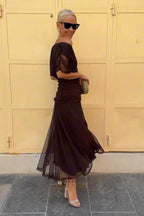 Women wearing the Harrow Amira floral maxi dress with off-shoulder design, perfect for cocktail parties, featuring a dreamy floral pattern.