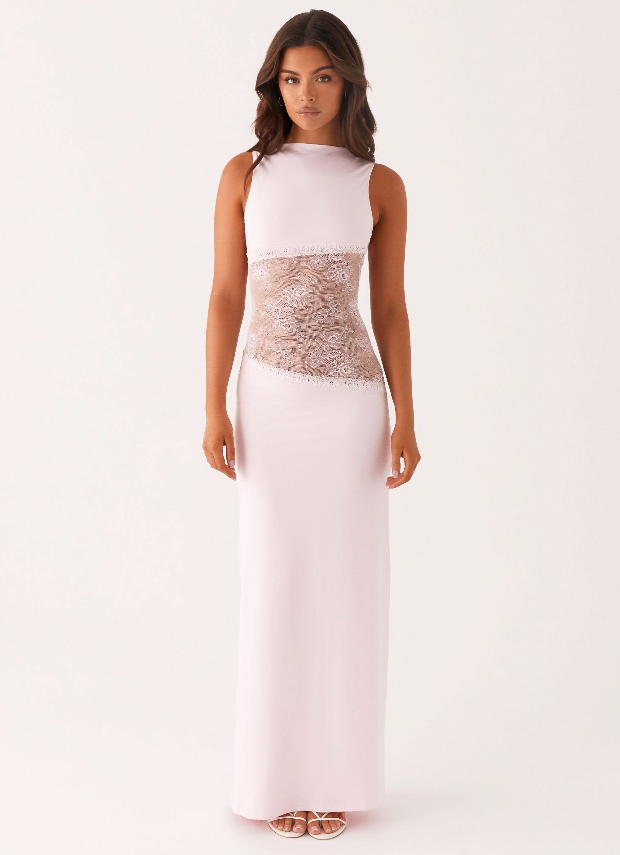 Women wearing a sleeveless lace cutout maxi dress by Harrow, elegant style perfect for cocktail parties.