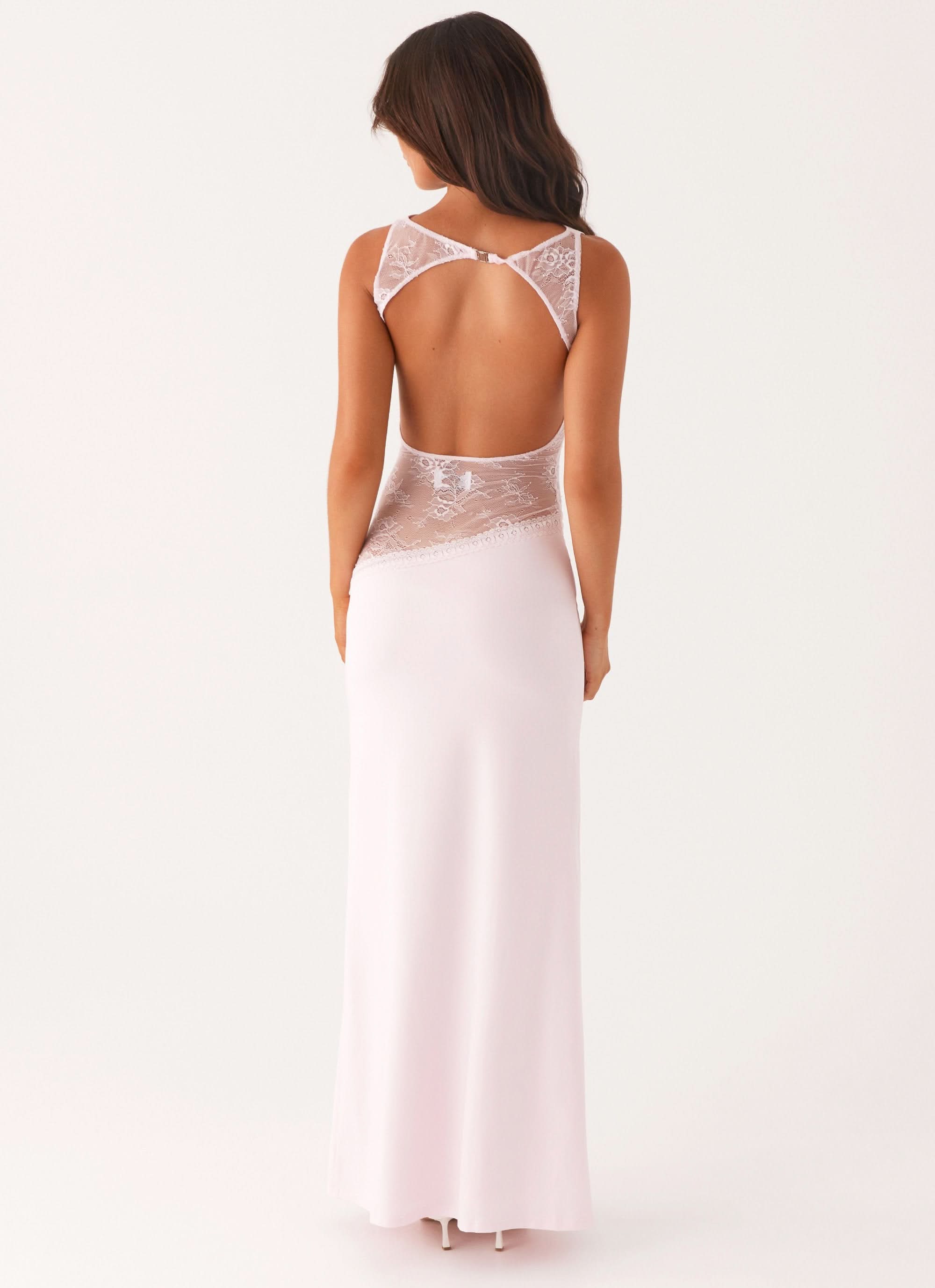 Women wearing a sleeveless lace maxi dress by Harrow, elegant cutout design perfect for cocktail parties.