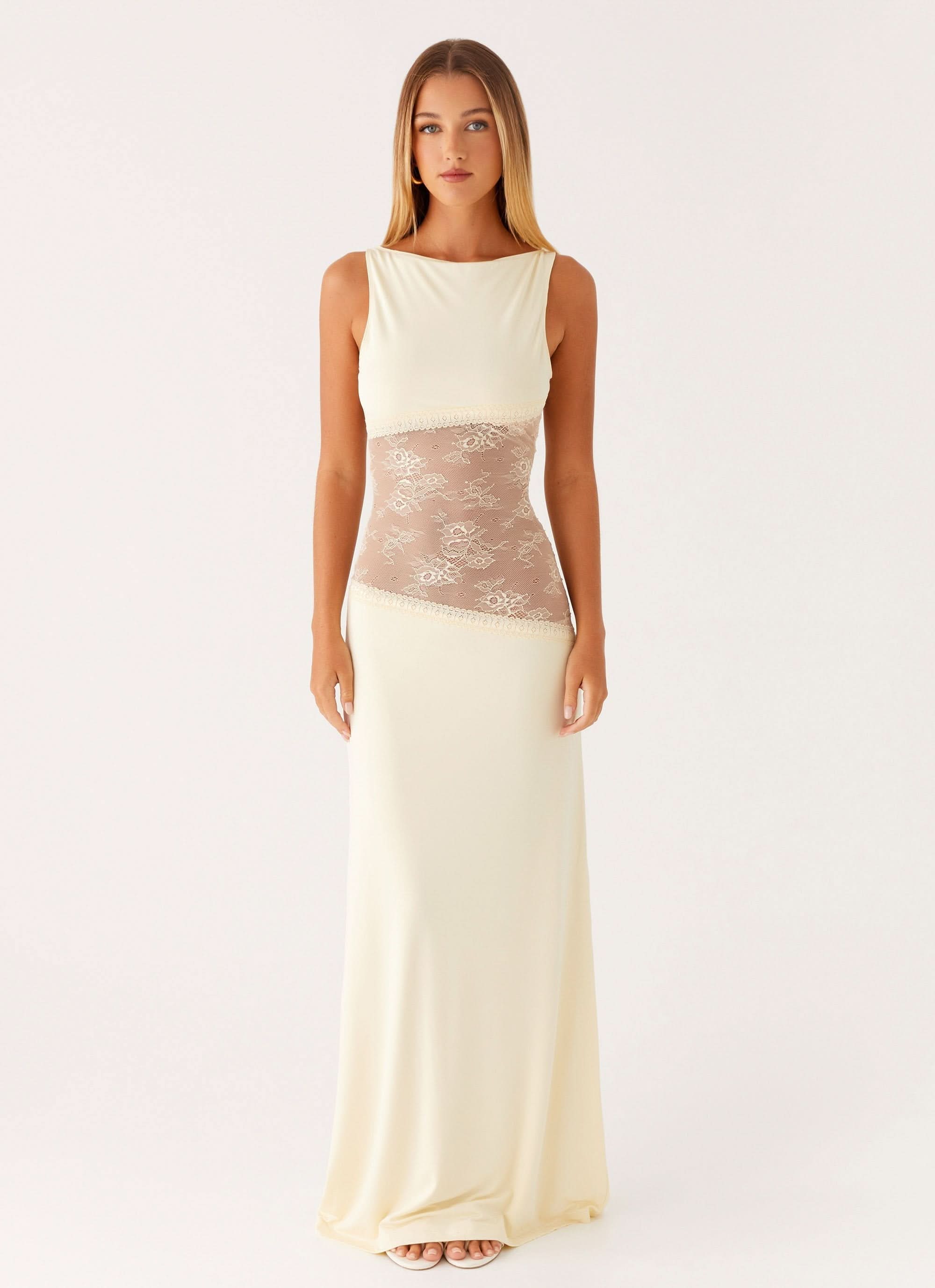 Women wearing a sleeveless lace maxi dress with cutout details, elegant style for cocktail parties by Harrow Ariel.