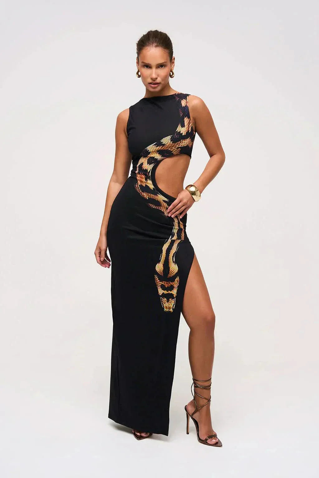 Women wearing the Harrow Arielle printed maxi dress with snake print and cutout details, perfect for cocktail parties.