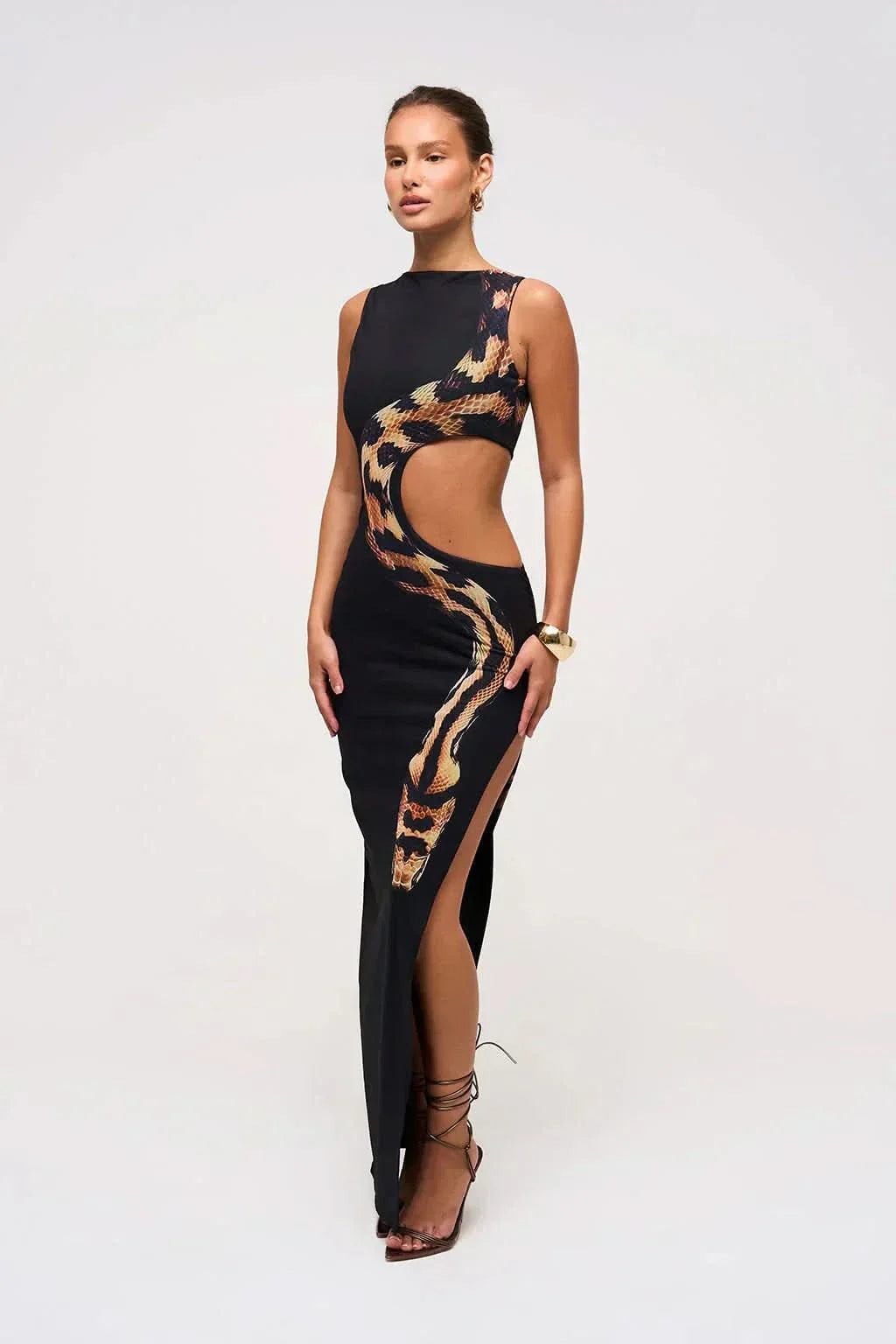 Women wearing the Harrow Arielle printed maxi dress with snake print and cutout details, perfect for cocktail parties.