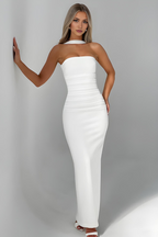 Women wearing the Audra sleek ruched bodycon maxi dress with a strapless design and matching scarf for cocktail parties.