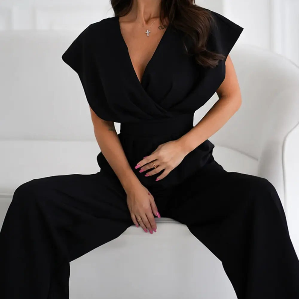 Women wearing Harrow Bonnie wide leg V-neck jumpsuit with flutter sleeves, showcasing elegant style and flowing fabric.