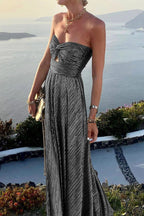 Women in a glamorous metallic sequin maxi dress by Harrow, strapless with pleated design, perfect for formal events.