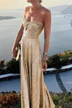Women wearing the Harrow Britta Glamorous Sequin Maxi Dress with strapless, pleated metallic fabric for formal events.