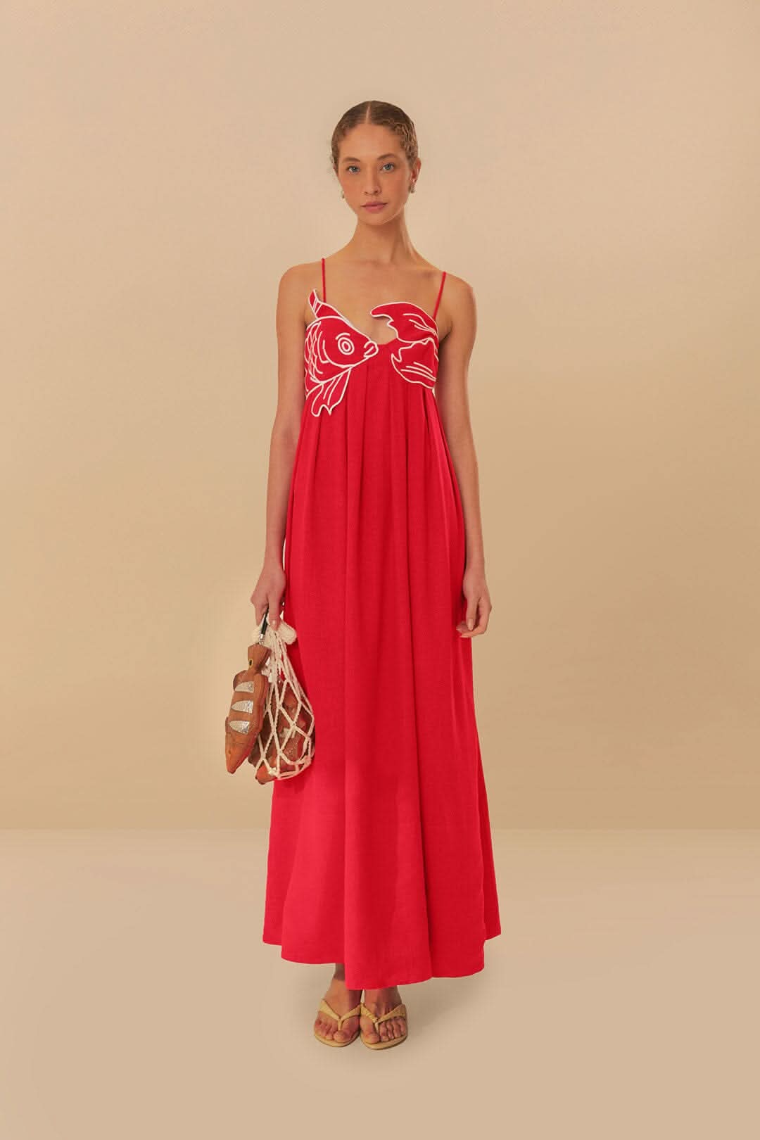 Women wearing the Chiara playful fish print maxi dress with spaghetti straps by Harrow, perfect for summer and casual occasions.