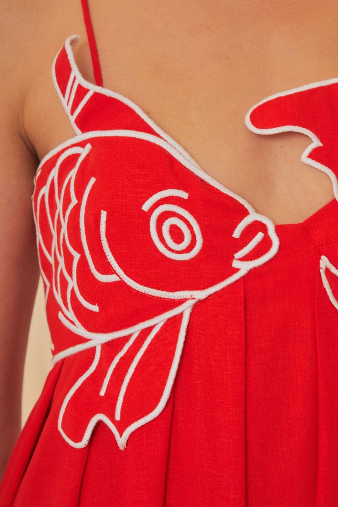 Women wearing Harrow Chiara playful fish print spaghetti strap maxi dress, summer style, flowing fabric, and vibrant aquatic pattern.