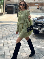 Women wearing a playful ruffle mini dress with long sleeves and a round neck by Harrow, perfect for summer occasions.