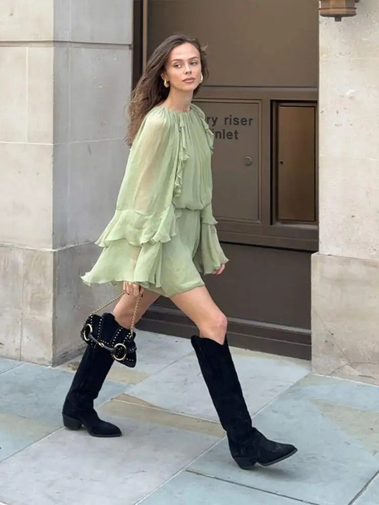Women wearing Harrow Crystal playful ruffle mini dress with long sleeves and round neckline, perfect for summer occasions.
