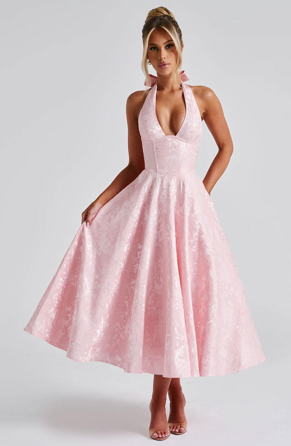 Women wearing Harrow Edith dreamy floral halter midi dress, perfect for wedding guests, showcasing elegant floral pattern.