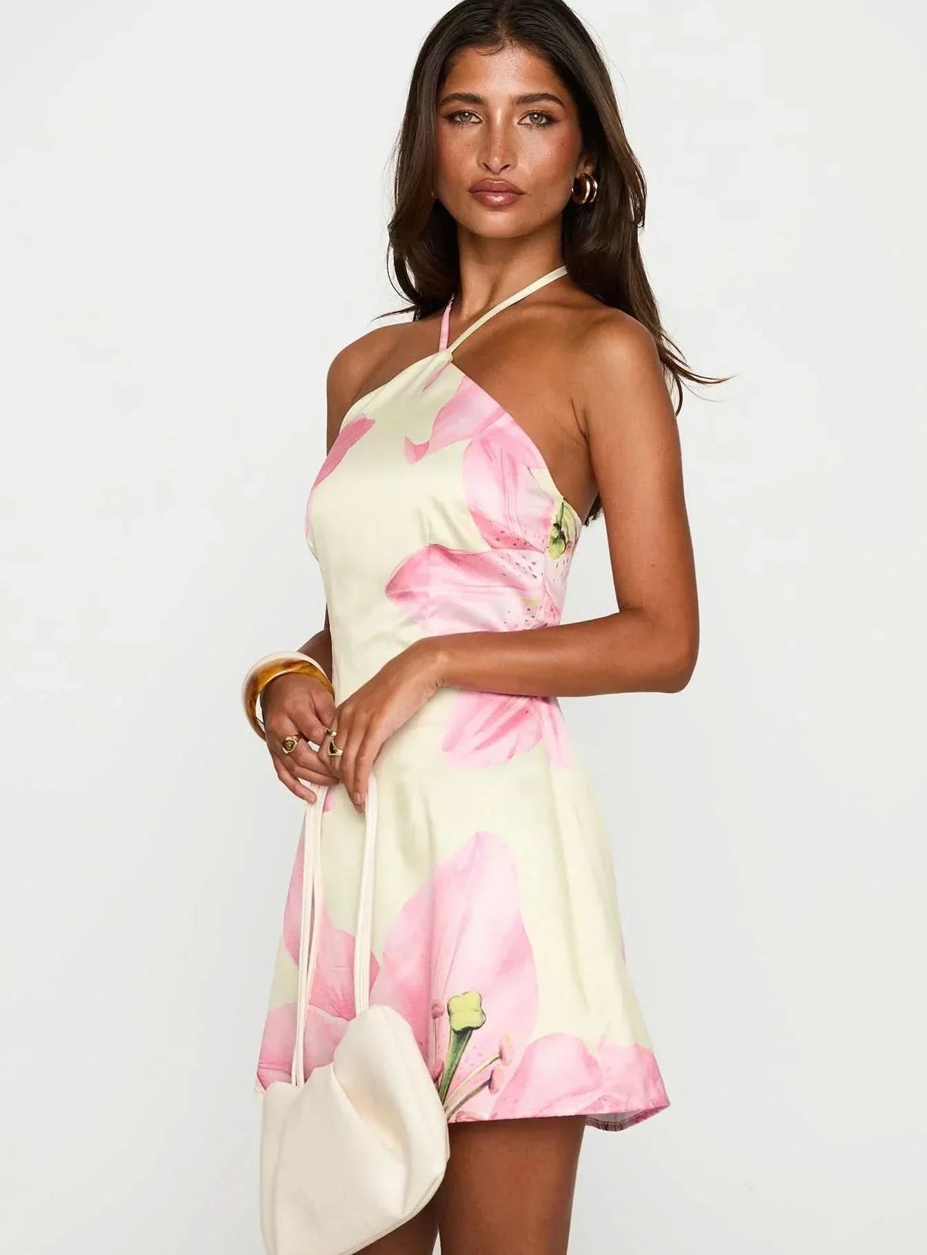 Women wearing the Edna floral halter mini dress by Harrow, perfect for wedding guests, featuring a dreamy floral design.