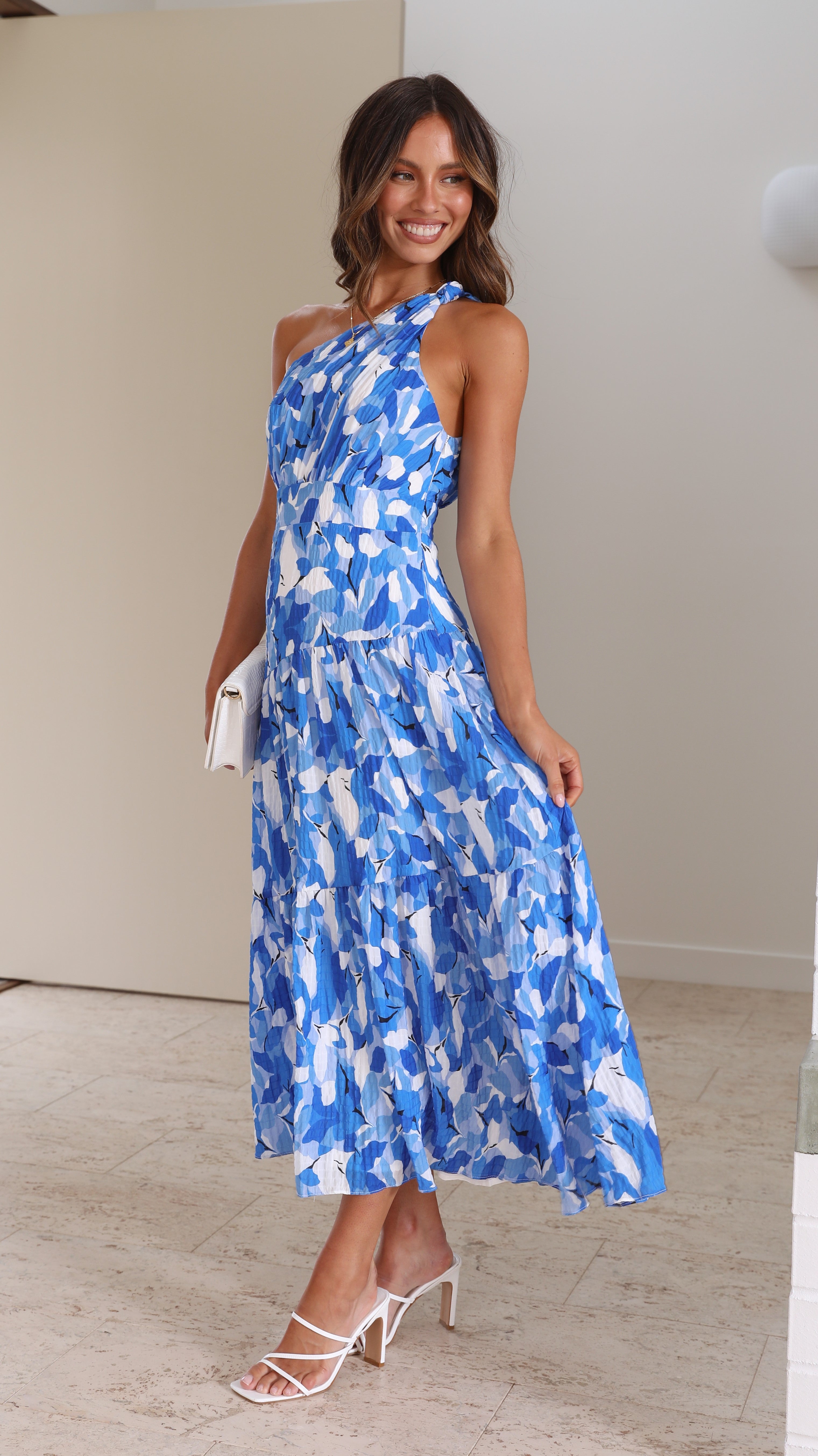 Women wearing the Harrow Elodie floral maxi dress with one shoulder, perfect for wedding guests, featuring a dreamy floral pattern.