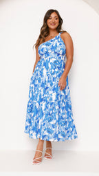 Women wearing the Elodie floral maxi dress by Harrow, a one-shoulder wedding guest dress with a dreamy floral pattern.