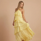 Women wearing the Fleur playful ruffle maxi dress by Harrow, halter neck, tiered design, perfect for wedding guests.