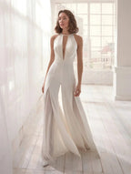 Women wearing Harrow Frances elegant halter V-neck wide leg jumpsuit, perfect for wedding guests.