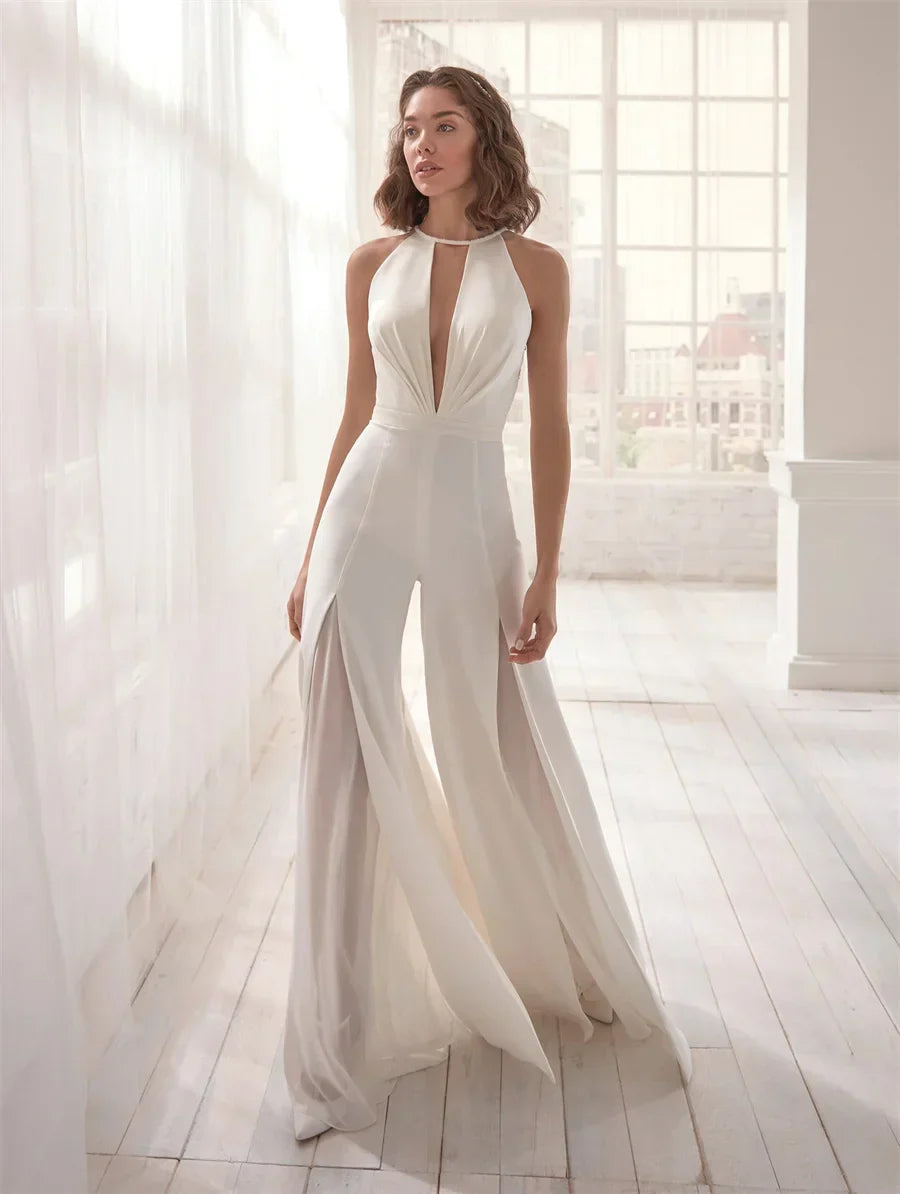Women wearing Harrow Frances elegant halter V-neck wide leg jumpsuit, perfect for wedding guests.