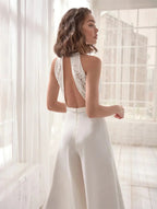 Elegant women’s halter V-neck wide-leg jumpsuit by Harrow, perfect for wedding guests, featuring a stylish silhouette and flowing fabric.