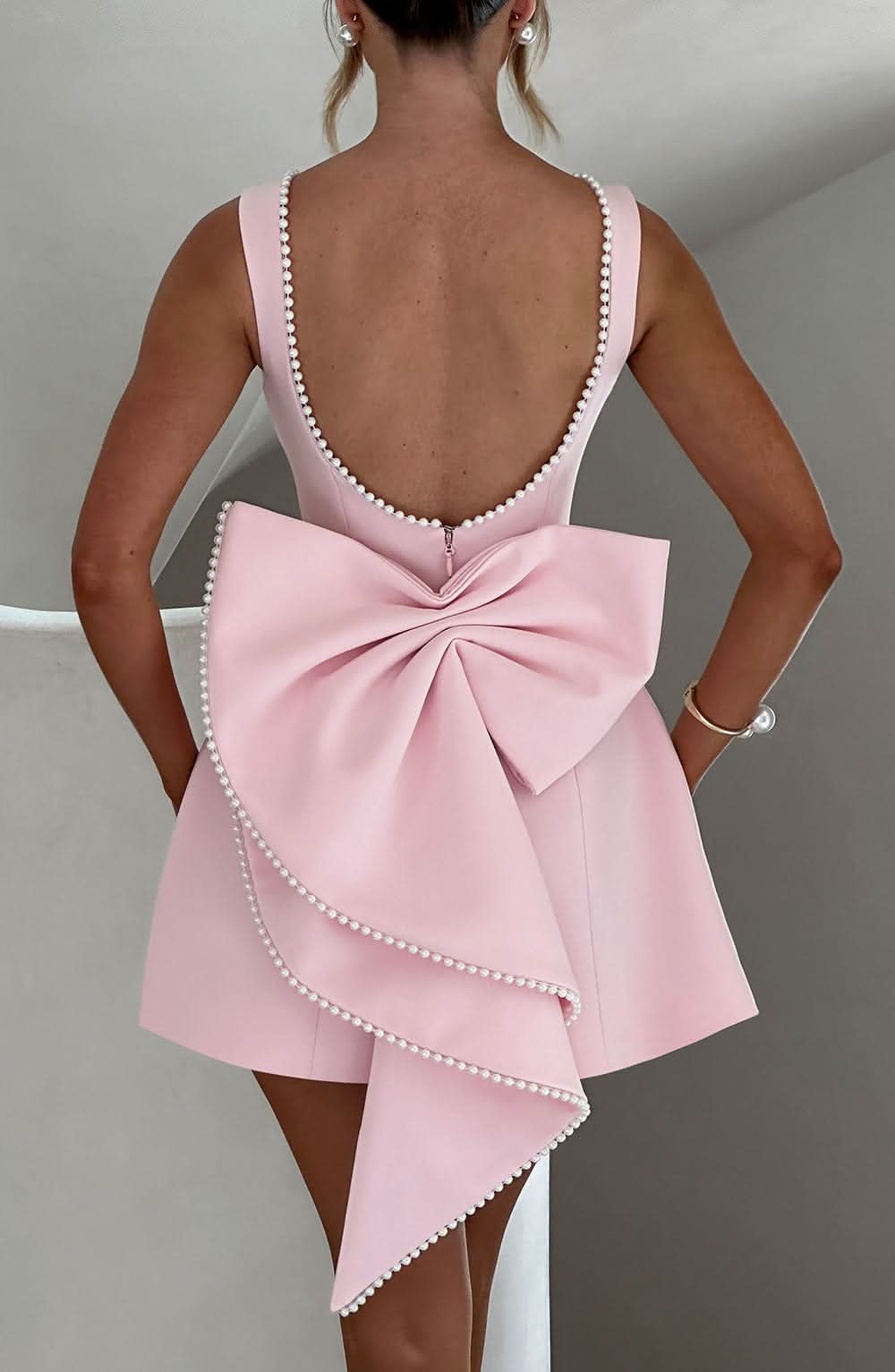Harrow Giovanna sleeveless mini dress with pearl trim, perfect for women attending weddings, featuring elegant design and fitted silhouette.
