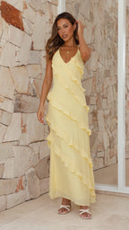 Women wearing Harrow's Greer playful ruffle halter maxi dress, perfect for wedding guests, featuring vibrant ruffle details and elegant style.