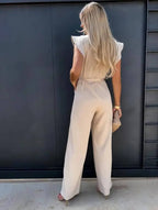 Elegant black ruffle sleeve wide-leg jumpsuit for women, perfect for wedding guests, by Harrow, showcased on a model.