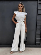 Women wearing the Harriet Harrow wedding guest jumpsuit with ruffle sleeves and wide-leg design, suitable for elegant occasions.