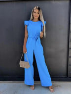 Women wearing the Harriet elegant ruffle sleeve wide-leg jumpsuit by Harrow, perfect for wedding guests, showcasing stylish ruffle details.