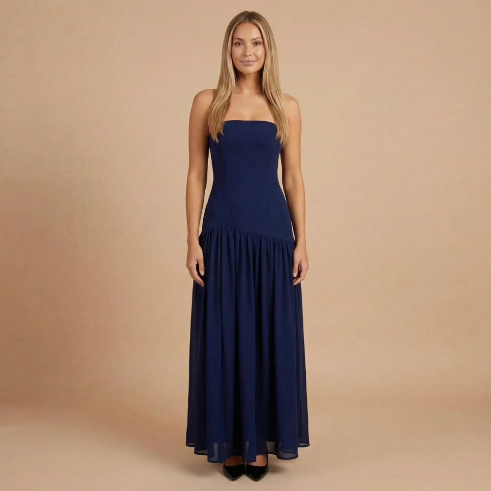 Elegant strapless maxi dress for wedding guests with a side slit, designed by Harrow, featuring a flowing silhouette and sophisticated style.