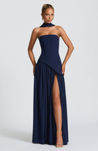 Elegant strapless maxi dress by Harrow for wedding guests, featuring a stylish slit and flowing fabric.