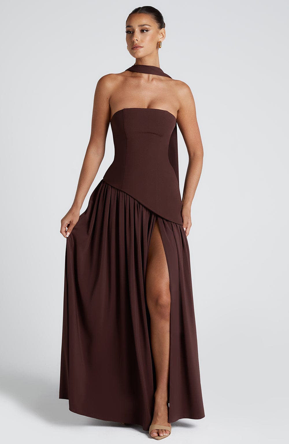 Elegant strapless maxi dress for wedding guests with a slit, by Harrow, featuring a flowing silhouette and sophisticated style.
