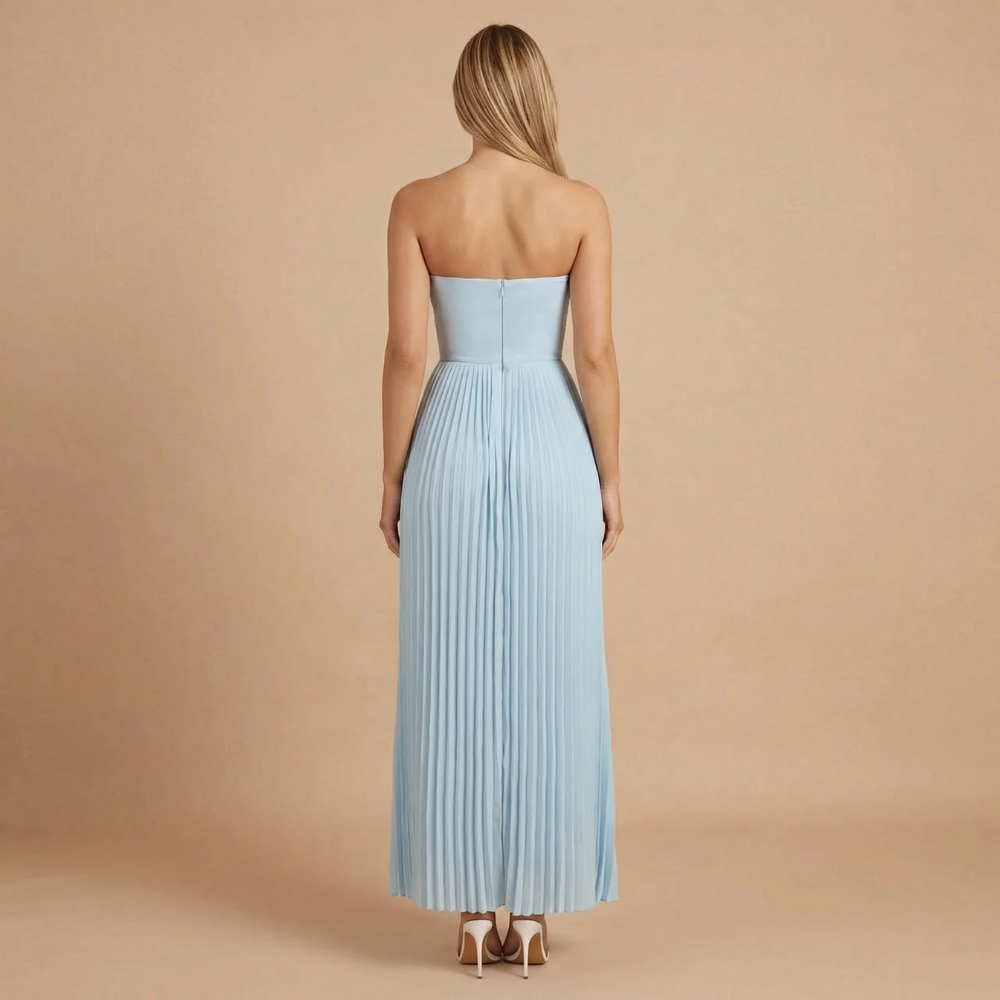 Women wearing the Harrow Ingrid elegant pleated strapless maxi dress, suitable for wedding guests, showcasing flowing fabric and sophisticated style.