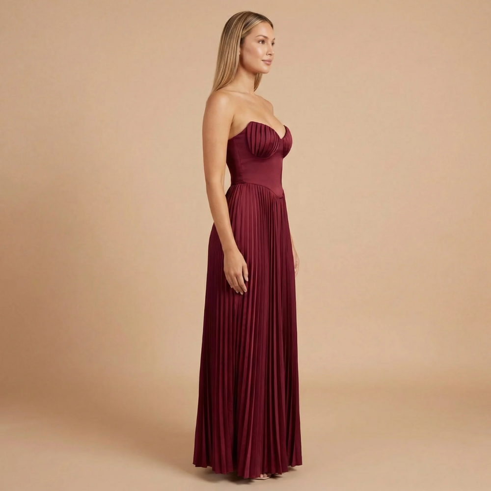 Elegant strapless pleated maxi dress by Harrow, perfect for women attending weddings, featuring flowing fabric and a sophisticated design.