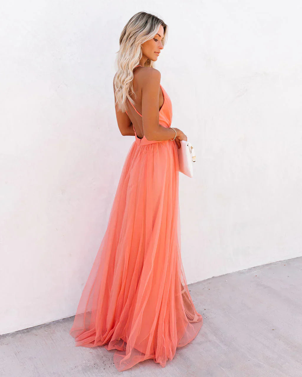 Women wearing the Ivana elegant maxi dress by Harrow, featuring a V-neck and strappy design, suitable for wedding guests.